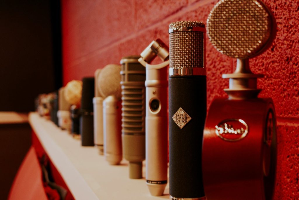 Microphones lined up on a shelf