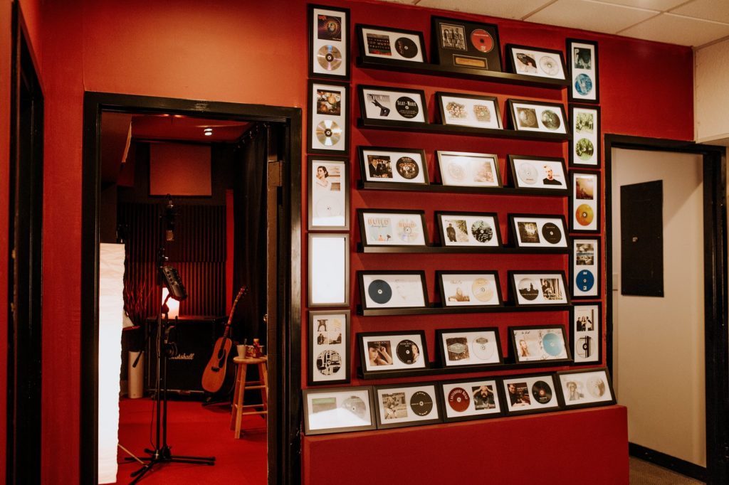 Framed artist albums hang on a wall at F5 SoundHouse