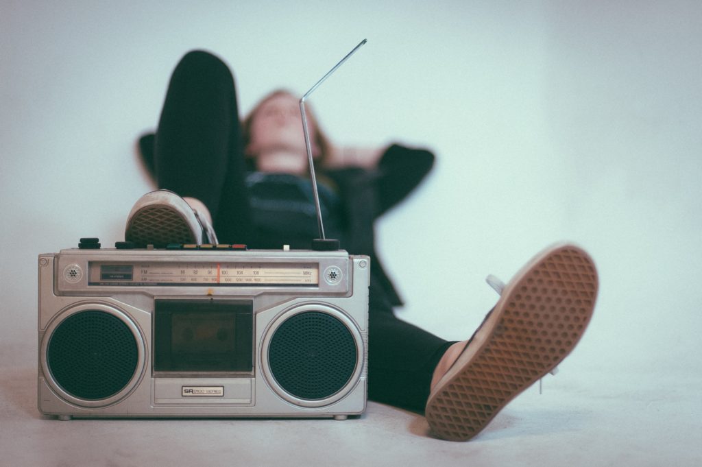 Man lying back with foot on old boom box