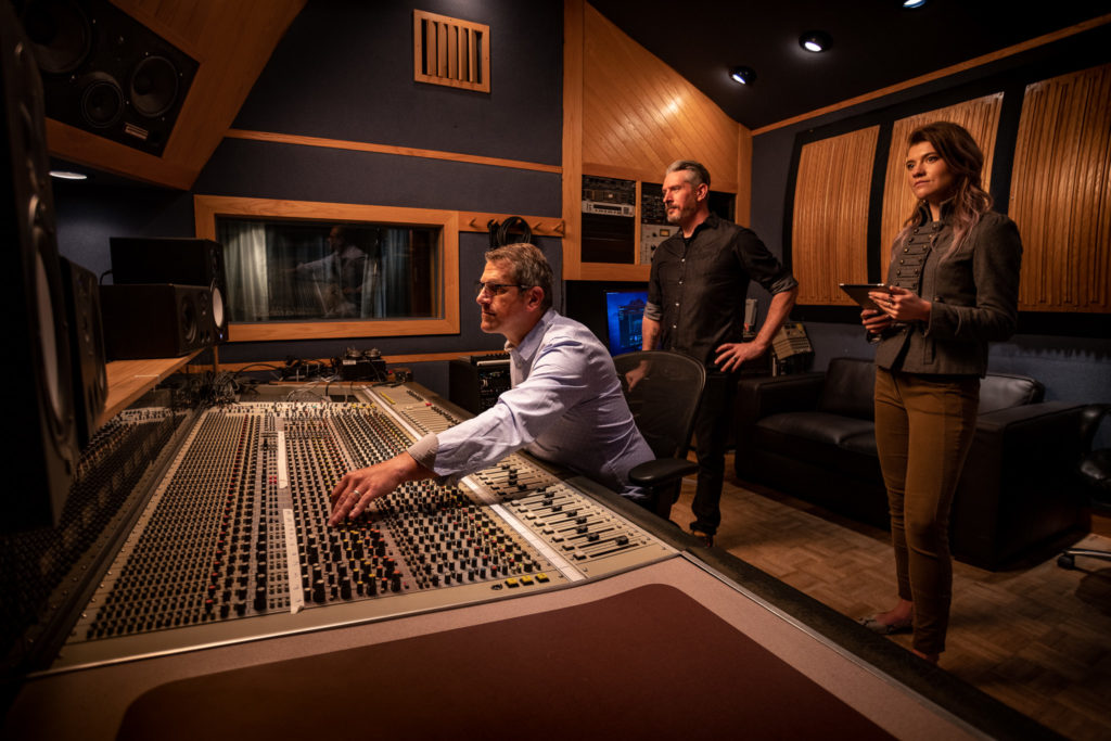 Davide Raso, Owen Sartori, and Elsa Lee working in a music studio